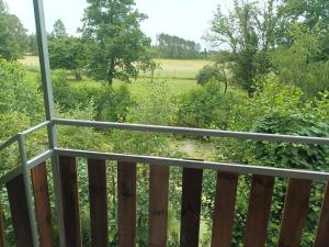 a balcony with a view of a field at Śródziemie Erebor in Leśno