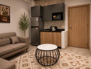 a kitchen with a couch and a table in a living room at StepInn in El Alamein