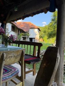 a table and chairs on a patio with a house at Malajac Bigrenica in Bigrenica +21 photos