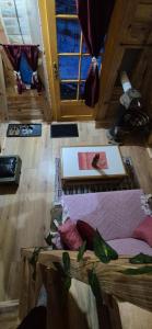 a living room with wood floors and a room with tables at Malajac Bigrenica in Bigrenica
