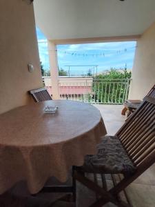 a table and chairs in a room with a balcony at Maja Apartmani in Sutomore +24 photos
