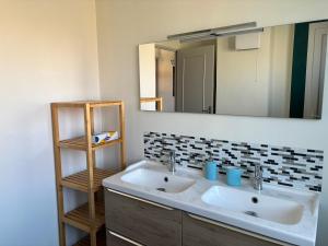 a bathroom with two sinks and a large mirror at La maison Champollion in Albi +37 photos