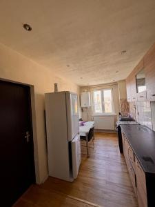 a kitchen with a white refrigerator in a room at Andra apartament in Petroşani