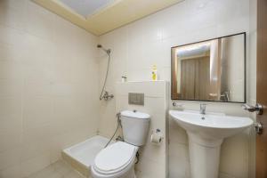 a white bathroom with a toilet and a sink at Bloomfields 2BR+Maid in Mina Fajer - Fujairah in Fujairah +32 photos