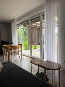 a bedroom with a bed and a table and a dining room at Wrzosowisko Sominy in Sominy