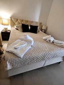 a bedroom with a large bed with towels on it at Sunset Aura in Sukošan