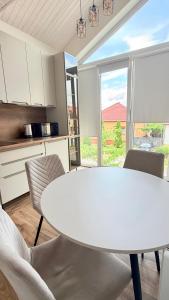 a kitchen with a white table and chairs at Yu-home 2 in Mukacheve +7 photos