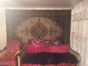 a bedroom with a bed with two heart pillows at Guesthouse Adis in Kyzart