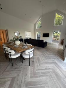 a living room with a wooden table and chairs at Cour Cottage in Drem