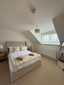 a bedroom with a large bed and a window at Cour Cottage in Drem