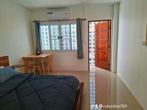 a bedroom with a bed and a window and a table at @888byChefKong in Ko Tao