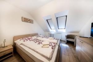 a bedroom with a bed with red flowers on it at Penzión Bergmannhof in Ladomer +38 photos