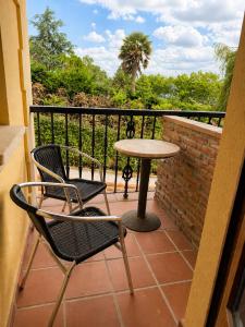 a patio with two chairs and a table on a balcony at Posada El Valle - Adults Only in Suances