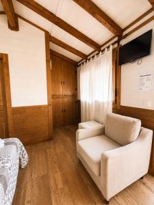 a living room with a couch and a tv at Posada El Valle - Adults Only in Suances