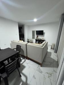 a living room with a couch and a table at Depa Ángel in Moyobamba +3 photos