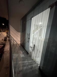 a building with a glass door and a window at Depa Ángel in Moyobamba
