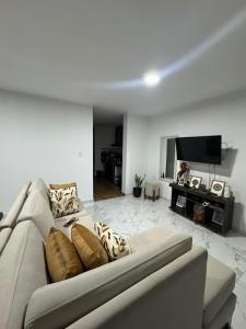 a living room with a couch and a television at Depa Ángel in Moyobamba