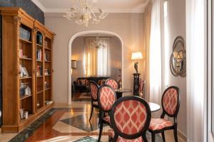 a dining room with chairs and a table and a living room at La Villa in Siena