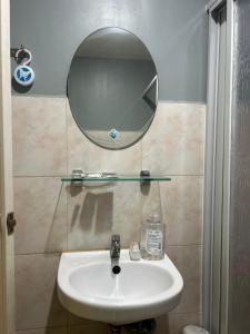 a bathroom with a sink and a mirror on the wall at Davao Cozy Condo unit 1 in Davao City +10 photos