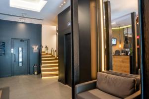 a hallway with a staircase and a door with a couch at Hotel Paseo de Gracia in Barcelona
