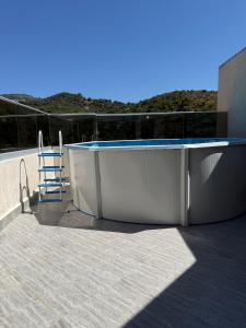 a chair sitting next to a bath tub on a roof at Appartement El-Chahed in Annaba