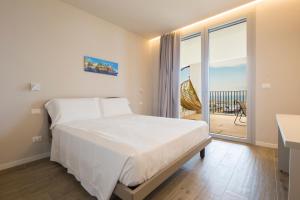 a bedroom with a large bed and a balcony at VillaPignone in Genoa
