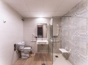 a bathroom with a toilet and a sink and a shower at Hotel Tropic in Cala de Finestrat +13 photos
