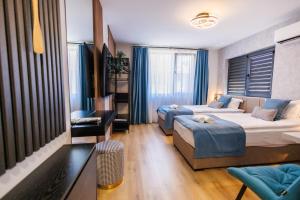 a bedroom with two beds and a table and chairs at Boulevard Hotel in Aytos +277 photos
