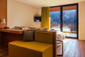 a bedroom with a bed and a large window at Silou Retreat in Champdepraz