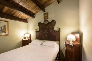 a bedroom with a large bed with two night stands at Villa Fozzi in Bonorva