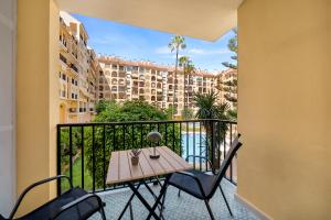 a balcony with a table and chairs and a view of a building at Jomarijo Boutique Rooms in Fuengirola +24 photos