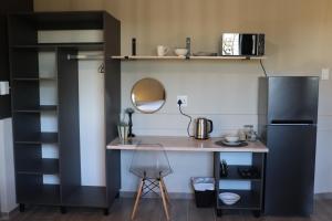 a kitchen with a desk and a refrigerator at Favour House in Bethlehem