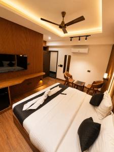 a bedroom with a large bed and a flat screen tv at Casa Grande in Srinagar +11 photos