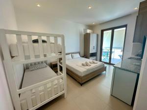 a bedroom with two bunk beds and a balcony at HODO in Orikum