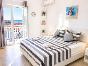 a bedroom with a bed with a view of the ocean at Villa Bingo in Cavtat