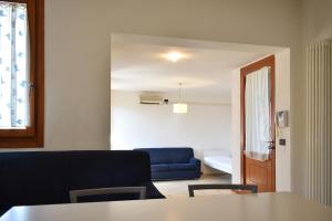 a living room with a blue couch and a table at Welc-ōM Conselve Matteotti in Conselve