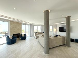 a large living room with couches and a fireplace at Seaview Panorama Villa in Drousha