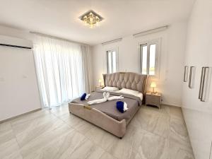 a bedroom with a bed and a large window at Seaview Panorama Villa in Drousha +49 photos