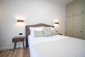 a bedroom with a large white bed with two pillows at Aida's Apartment Nafplio in Nafplio