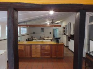 a kitchen with a large island in a room at Ashtonville Terraces Guesthouse in Estcourt