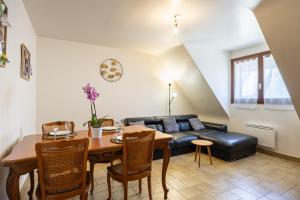 a living room with a table and a couch at Gîte Le Lot in Espalion