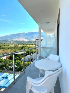 a balcony with a white table and two chairs at HODO in Orikum