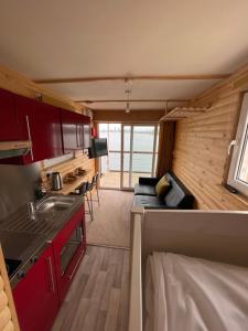 a kitchen and living room in a tiny house at Lake View Lodge Pod in Chichester