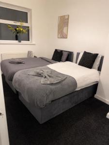 a bedroom with two beds and a window at 2 bedroom Large House For Contractors, And Family with a sofa bed in Shildon