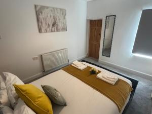 a room with a bed with two towels on it at Scorpio 1 in Burton upon Trent
