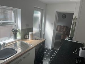 a kitchen with a sink and a counter top at Scorpio 1 in Burton upon Trent