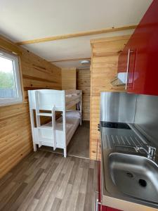 a small kitchen with a sink and a refrigerator at Lake View Lodge Pod in Chichester +9 photos