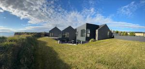 a house sitting on top of a grass field at Slate House in Ballybunion