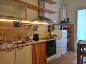 a kitchen with a sink and a stove at La casetta di Elena - Sondrio Valtellina in Sondrio +10 photos