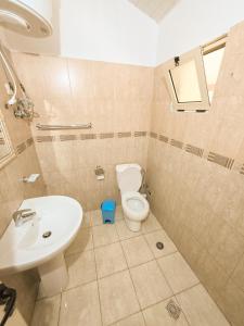 a bathroom with a toilet and a sink at Sunrise Dhermi Beach in Dhërmi +1 photo